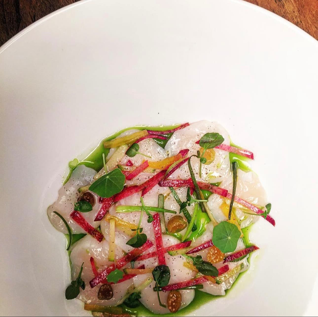 Scallop crudo | radish julienne | herb oil | nasturtium